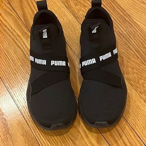 Women’s Puma black and white sneakers.